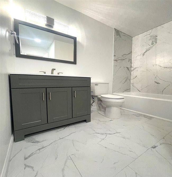 Bathroom with baseboards, toilet, vanity, and marble finish floor | Image 14