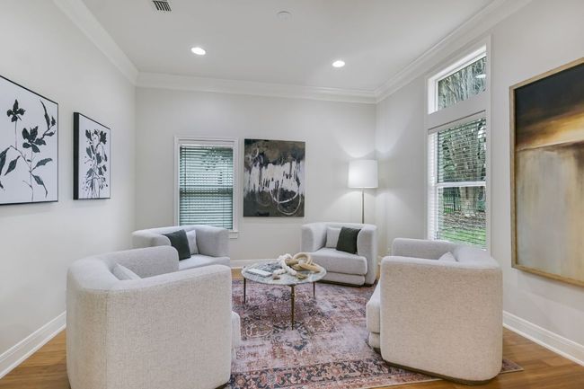 Secondary living room featuring beautiful natural light, crown molding, and plenty of entertaining space. | Image 8