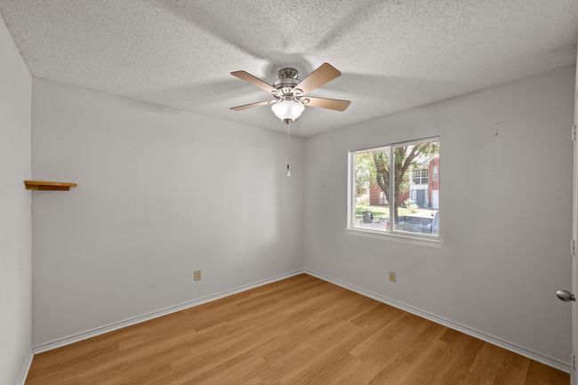 Empty room featuring light wood-style floors, ceiling fan | Image 28