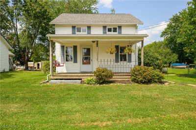 Bungalow-style house featuring covered porch and a front lawn | Image 3