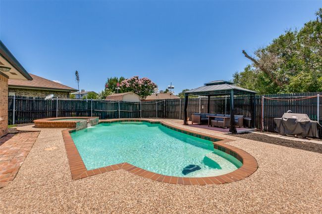 View of pool with a patio, a gazebo, outdoor lounge area, and a fenced backyard | Image 24