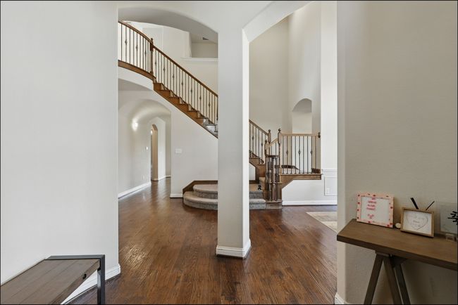 Foyer entrance with dark wood-style floors, a high ceiling, and ceiling fan | Image 4
