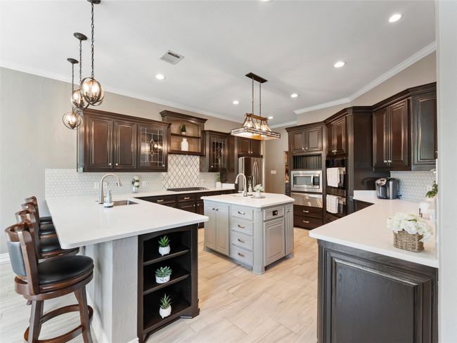 Kitchen featuring open shelves, appliances with stainless steel finishes, a peninsula, light countertops, and recessed lighting | Image 18