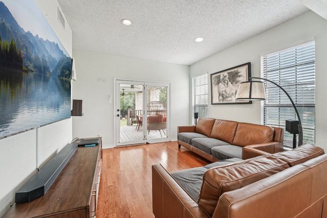 Living room featuring a textured ceiling, light wood-style flooring, and recessed lighting | Image 5