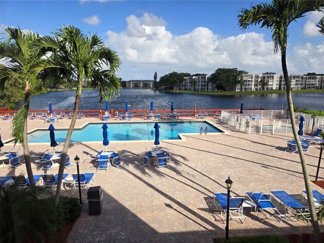 Clubhouse Pool Overlooking Lake And Water Fountain | Image 28