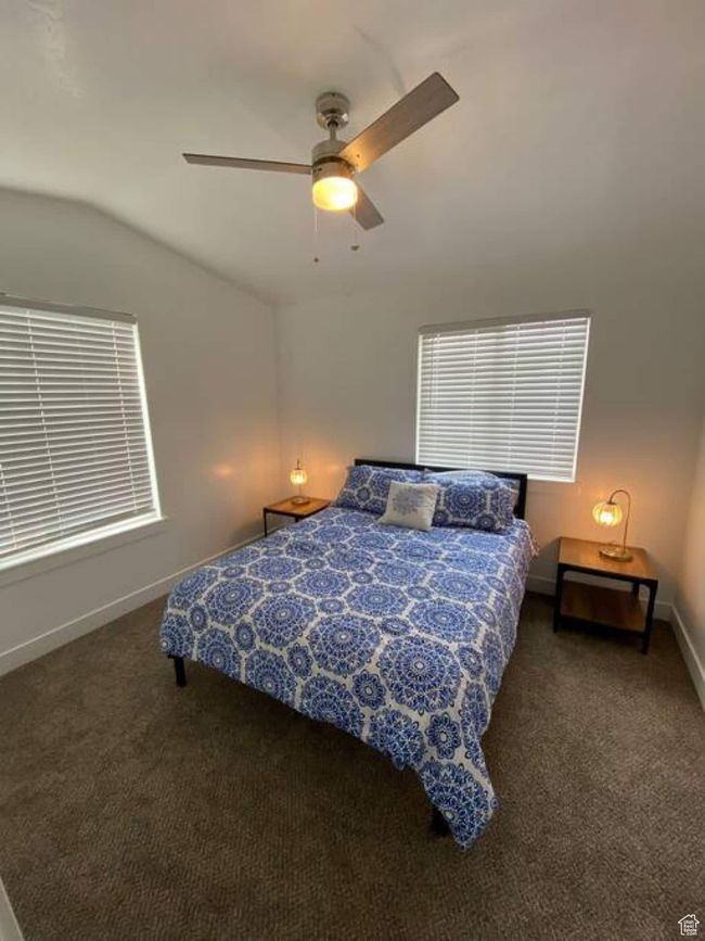 Bedroom featuring vaulted ceiling, carpet, baseboards, and a ceiling fan | Image 25