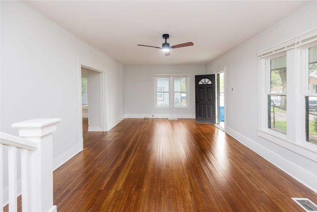 Empty room with hardwood / wood-style flooring, baseboards, ceiling fan, and ornamental molding | Image 31