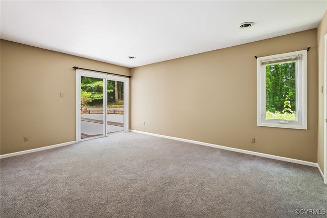 Empty room featuring healthy amount of natural light and carpet flooring | Image 15
