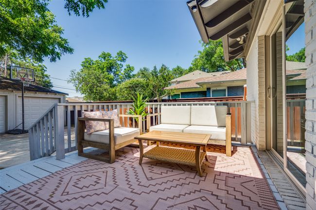 Wooden terrace featuring outdoor lounge area and an outbuilding | Image 18