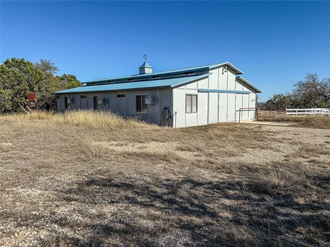 Rear view of house with a wall unit AC and fence | Image 18