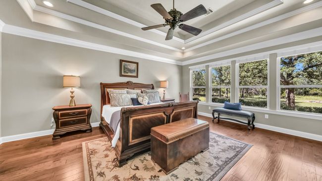 Bedroom with a tray ceiling, crown molding, hardwood / wood-style floors, recessed lighting, and ceiling fan | Image 30