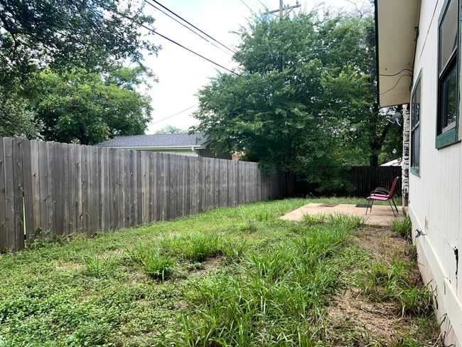 Fenced backyard with a patio | Image 23