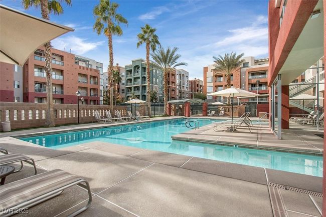 Community pool with a patio area and fence | Image 24