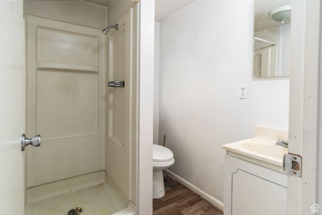 Bathroom with wood finished floors, a stall shower, and vanity | Image 24