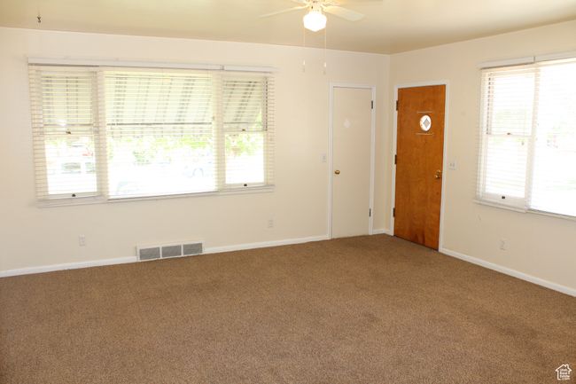 Carpeted spare room with ceiling fan and plenty of natural light | Image 25