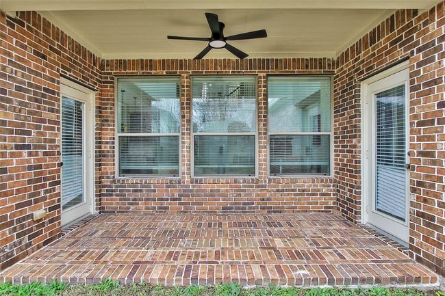 Covered patio with newly installed outdoor fan. | Image 45