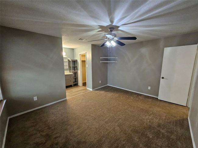 Carpeted spare room with a ceiling fan, baseboards, and visible vents | Image 21