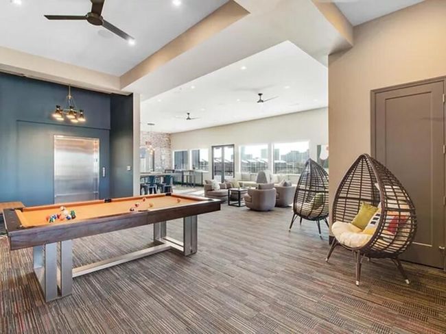 Game room featuring pool table, carpet flooring, and ceiling fan with notable chandelier | Image 16