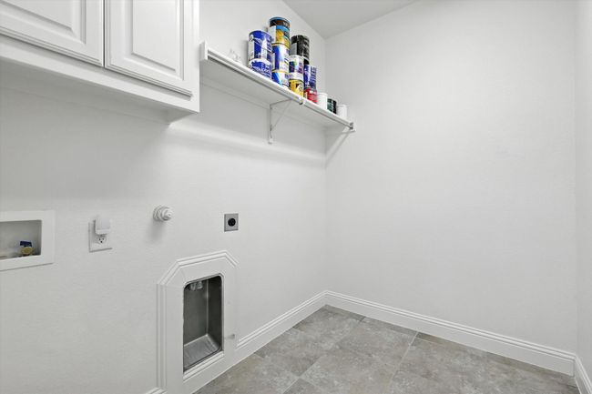 Laundry area featuring cabinet space, gas dryer hookup, electric dryer hookup, and washer hookup | Image 9