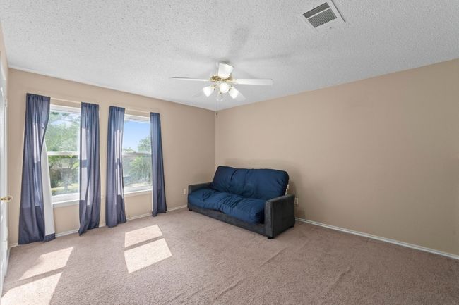 Unfurnished room featuring ceiling fan, carpet floors, a textured ceiling, and baseboards | Image 28