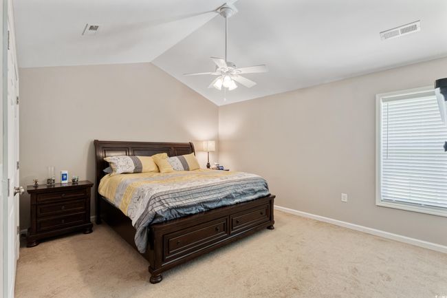 Bedroom with light colored carpet, lofted ceiling, and a ceiling fan | Image 19