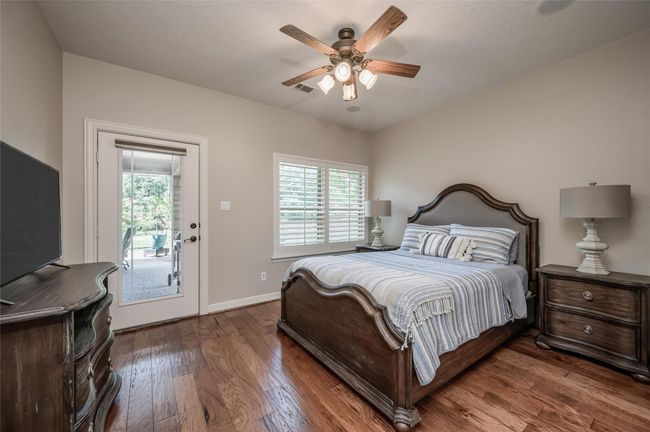 This inviting back bedroom features a queen-sized bed and direct access to the charming Winter Patio through elegant French door. | Image 19