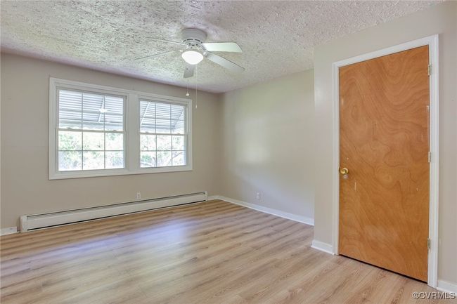 2nd featuring a textured ceiling, a baseboard radiator, ceiling fan, and light hardwood / wood-style floors | Image 15