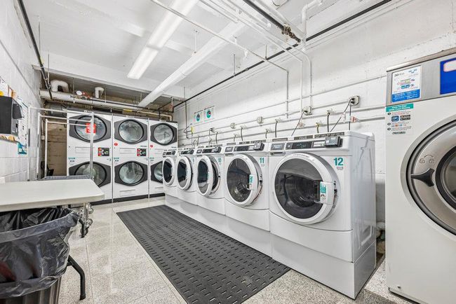 Community laundry room with stacked washer and clothes dryer and washer and clothes dryer | Image 10