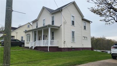 View of front of property with covered porch and a front yard | Image 2