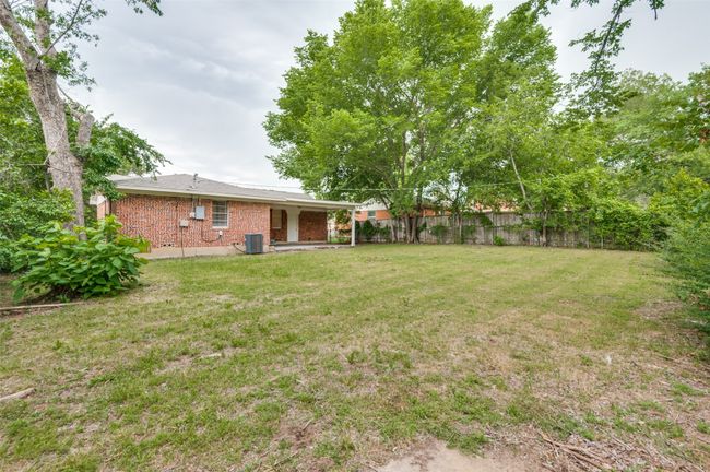 View of large back yard with covered patio | Image 26
