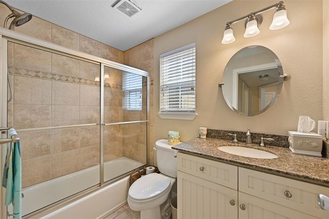 Large main-floor bathroom conveniently serves two bedrooms. | Image 16