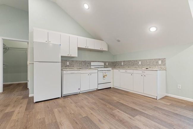 This cute little kitchen space features a sink, dishwasher, and fridge! | Image 31