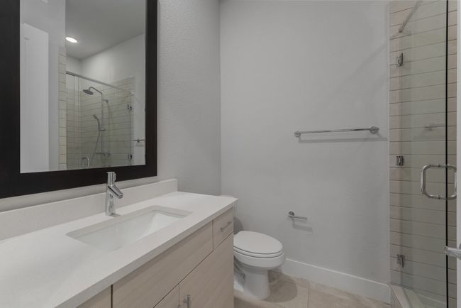 Bathroom with vanity, tile patterned flooring, a shower stall, and toilet | Image 8