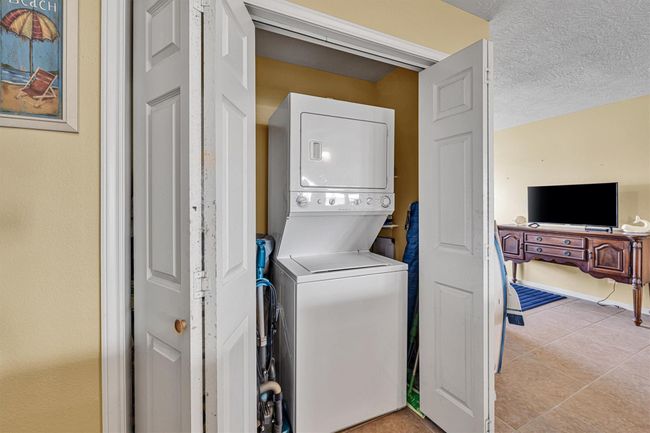 The full size washer and electric dryer are included and are centrally located within a double door closet. | Image 19