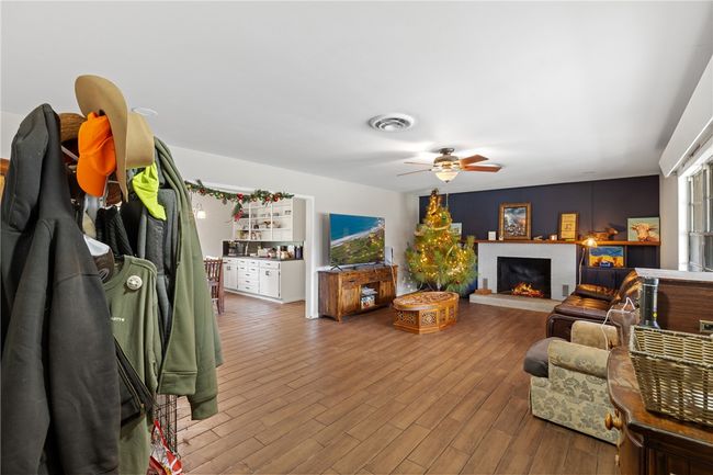 Living room with ceiling fan and wood-type flooring | Image 5
