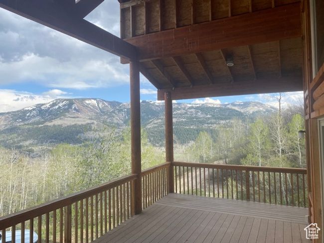 Wooden deck with a mountain view and a forest view | Image 14