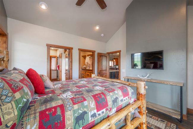 Bedroom featuring wood finished floors, connected bathroom, high vaulted ceiling, ceiling fan, and recessed lighting | Image 19
