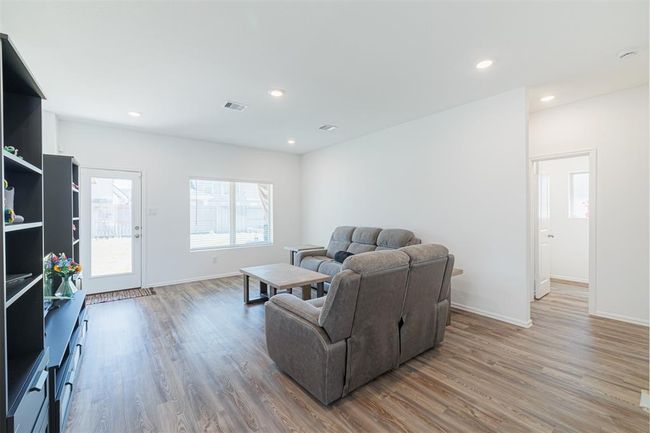 Door off the family room leads to the backyard and covered patio. | Image 9