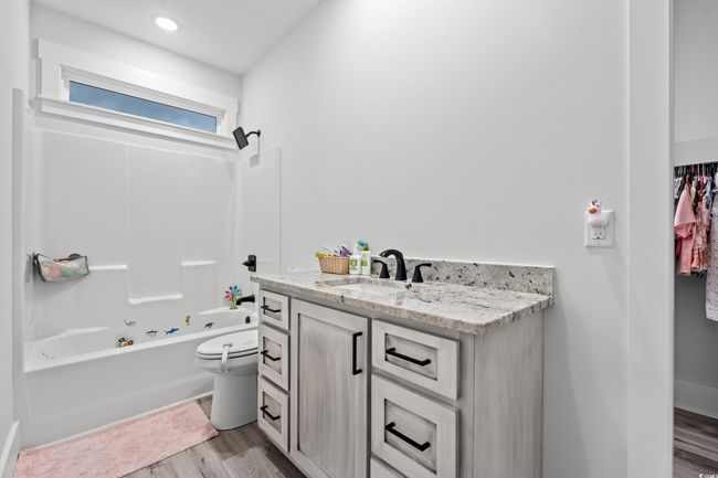 Bathroom featuring vanity, wood finished floors, and shower combination | Image 26