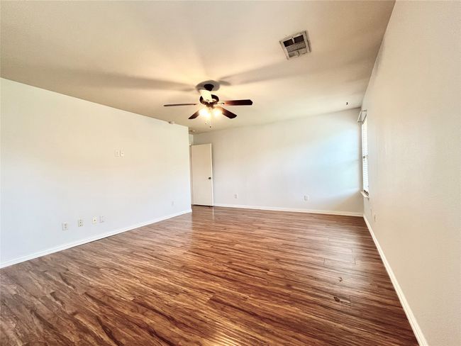 Spare room with a ceiling fan and dark wood finished floors | Image 18