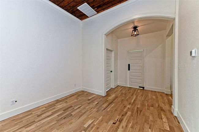 Dining area with arched walkways, wooden ceiling, and light wood-style floors | Image 14