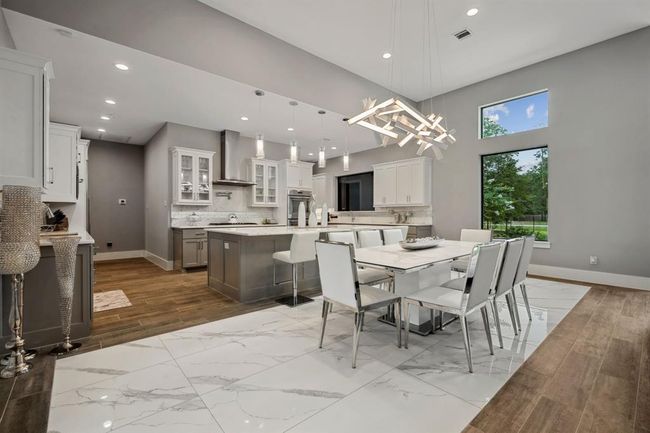 Premium appliances, a stunning center island, and dual sinks make meal preparation both effortless and enjoyable. | Image 13