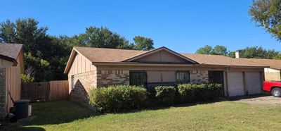 Single story home featuring a garage and a front lawn | Image 1