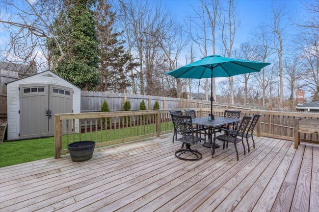 Wooden deck & lawn with a shed. Backyard fully fenced in. | Image 15