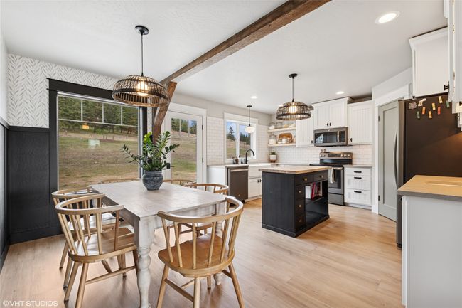 Dining room with beam ceiling, light wood finished floors, and recessed lighting | Image 11