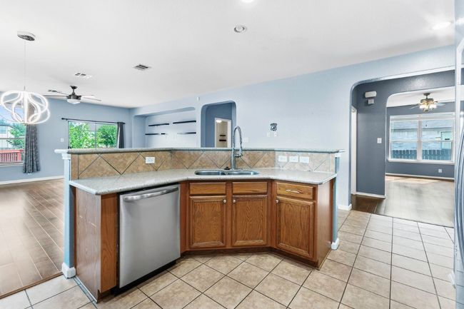 Kitchen with ceiling fan, arched walkways, and dishwasher | Image 15