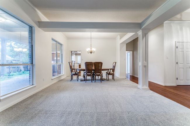 Dining room featuring plenty of natural light, ornate columns, carpet flooring, and ornamental molding | Image 6