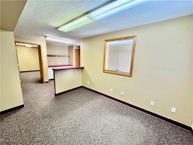 Carpeted empty room with a textured ceiling | Image 8