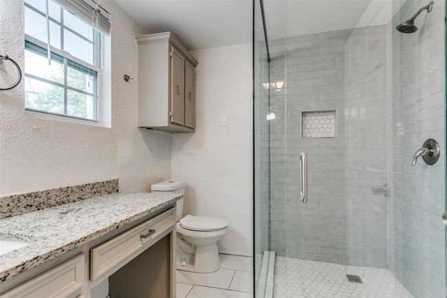 Bathroom featuring tile patterned floors, vanity, a shower stall, and toilet | Image 16