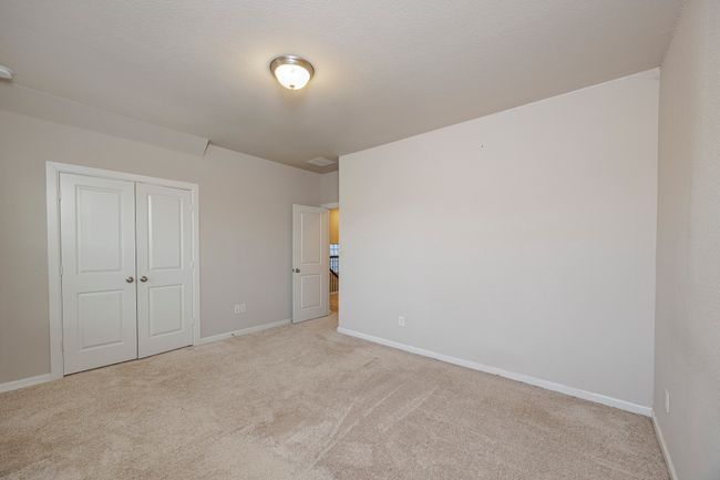 Unfurnished bedroom with light colored carpet and a closet | Image 27